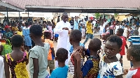 Very Reverend Father Stephen Amoah-Gyasi with some children in a photo