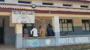 Men sit outside the general hospital in Basankusu, Democratic Republic of the Congo