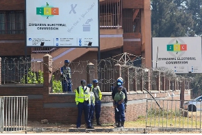 Police guard the offices of the Zimbabwe Election Commission as vote counting continues
