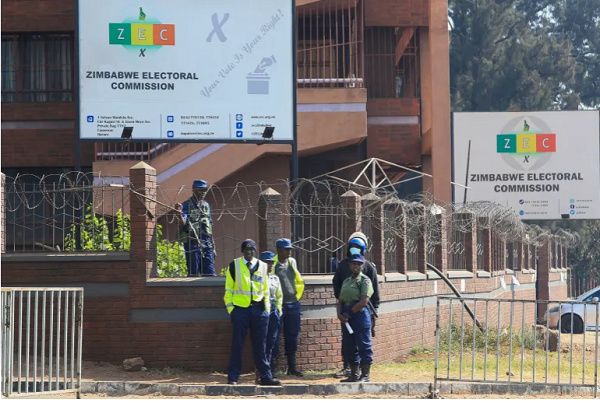 Police guard the offices of the Zimbabwe Election Commission as vote counting continues