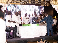 The invited guests join the celebrant to cut his E-Levy cake
