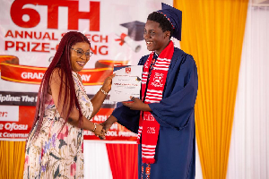 Wife of Speaker of Parliament, presenting a certificate to her son, Vielung Kwadwo Bagbin