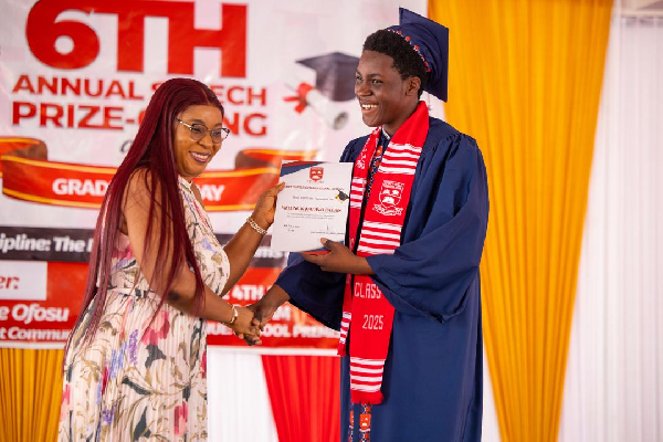 Wife of Speaker of Parliament, presenting a certificate to her son, Vielung Kwadwo Bagbin
