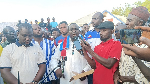 The NPP Tolon constituency secretary (in the middle) addressing the media