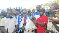 The NPP Tolon constituency secretary (in the middle) addressing the media