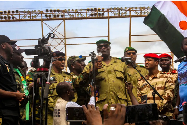 Members of a military council that staged a coup in Niger attend a rally at a stadium in Niamey
