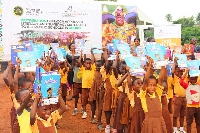 Basic pupils displaying the books donated to them