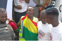 Seidu Rafiwu covered with a Ghana flag