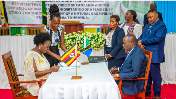 Officials from Uganda (L) and Tanzania (R)  signing a bilateral deal on November 9, 2023