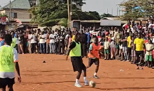Doku playing football with some locals in Madina