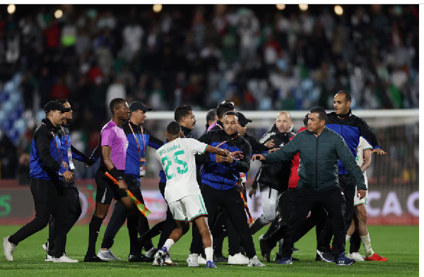 Algeria's Rafik Belghali clashes with match officials after the match