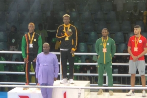 Samuel Takyi on the podium after winning gold