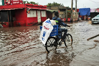 People walk through floodwaters in Maputo, Mozambique