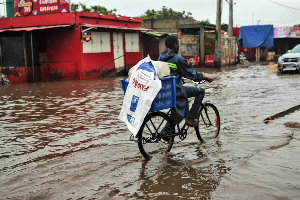 People walk through floodwaters in Maputo, Mozambique
