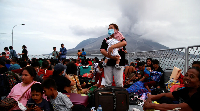 Families evacuate following eruptions of Mount Ruang volcano in North Sulawesi province, Indonesia