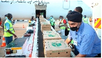 Workers load fresh produce on a cargo plane at Kisumu International Airport, Kenya