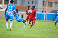 Kotoko's Patrick Aseidu receives a hard tackle