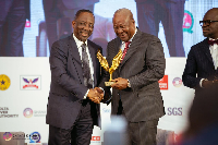 Alex Apau Dadey receiving the award from John Dramani Mahama