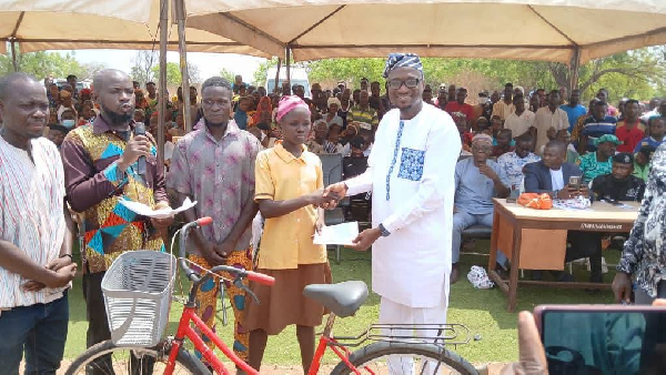 Salaga North MP, Alhaji Alhassan Mumuni, presenting a package to a girl child
