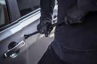 File photo of a man trying to break into a car