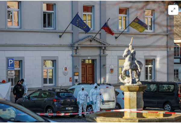 Members of the police secure the area following the shooting