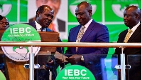 Wafula Chebukati (left) hands William Ruto his certificate after being declared president-elect