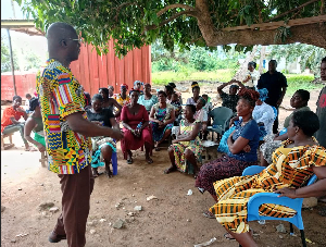 Executive Director of YOWE, Mr. Emmanuel Nuetey Siakwa seen talking to fishmongers