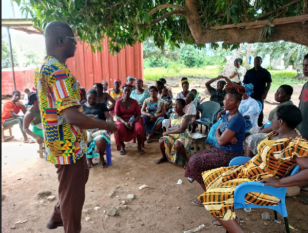 Executive Director of YOWE, Mr. Emmanuel Nuetey Siakwa seen talking to fishmongers
