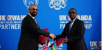 Home Secretary James Cleverly (R) signed the new treaty with Rwanda's foreign affairs minister (L)