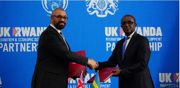 Home Secretary James Cleverly (R) signed the new treaty with Rwanda's foreign affairs minister (L)