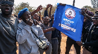 NRPUP supporters wave campaign flags outside Lusaka, Zambia