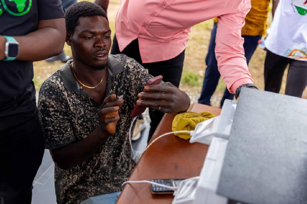 One of the residents of Ballagonnor enjoying electricity in the community through the initiative