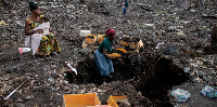 Kahindo, displaced by fighting, collects volcanic gravel for sale at an emptied IDP camp in Mugunga