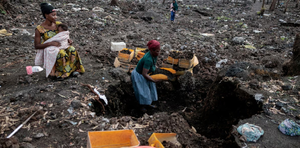 Kahindo, displaced by fighting, collects volcanic gravel for sale at an emptied IDP camp in Mugunga