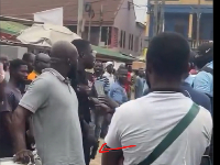 The police officer seen cocking his gun at the KMA official