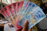 The cedi traded against the dollar at a mid-rate of 5.7512