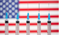 Syringes are seen in front of a displayed U.S. flag in this illustration taken Nov.10, 2020