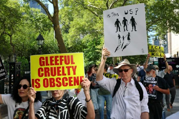 People march towards 26 Federal Plaza as they protest against Immigration and Customs Enforcement