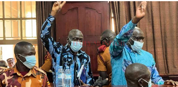 Col. Dr. Kizza Besigye and his co-accused Hajji Obeid Lutale Kamulegeya appear before the High Court