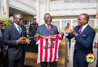 Chief Justice Paul Baffoe-Bonnie holding the Sunderland jersey with 'Visit Ghana' inscription