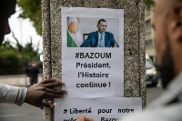 Demonstrators gather in front of the embassy of Niger in Paris in support of Mohamed Bazoum