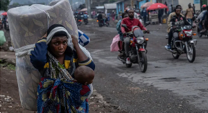 People displaced by the fighting with M23 rebels make their way to the centre of Goma, DR Congo