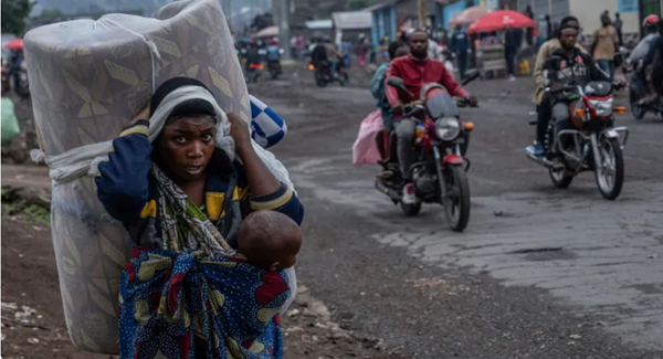 People displaced by the fighting with M23 rebels make their way to the centre of Goma, DR Congo