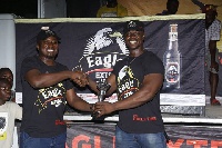 Derrick Kwakye receiving his prize from John Baptist Akado, Brands Manager of  Eagle Extra Stout