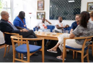 Vision FC boss Michael Osekre (blue) holding discussions with officials of the Danish ambassador