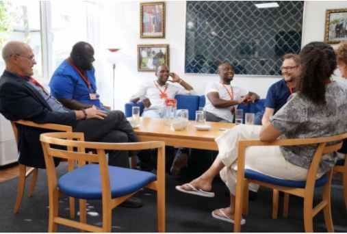 Vision FC boss Michael Osekre (blue) holding discussions with officials of the Danish ambassador