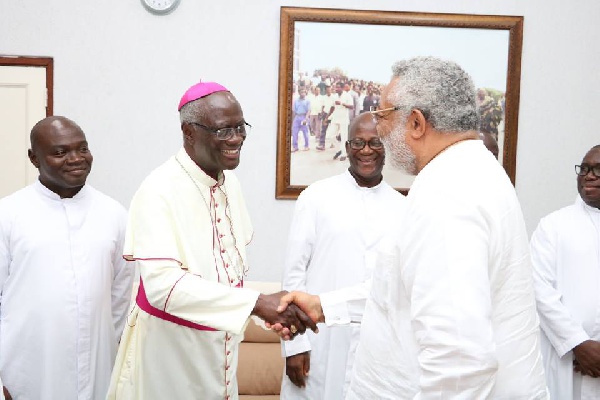 Archbishop Kwofie shaking hands with ex-president JJ Rawlings
