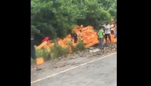 The crates of drinks fell off, with many residents rushing to salvage what they can