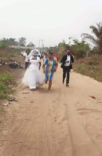 The bride running and followed by family and friends