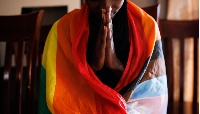 A member of the LGBTQ community prays during an evangelical church service